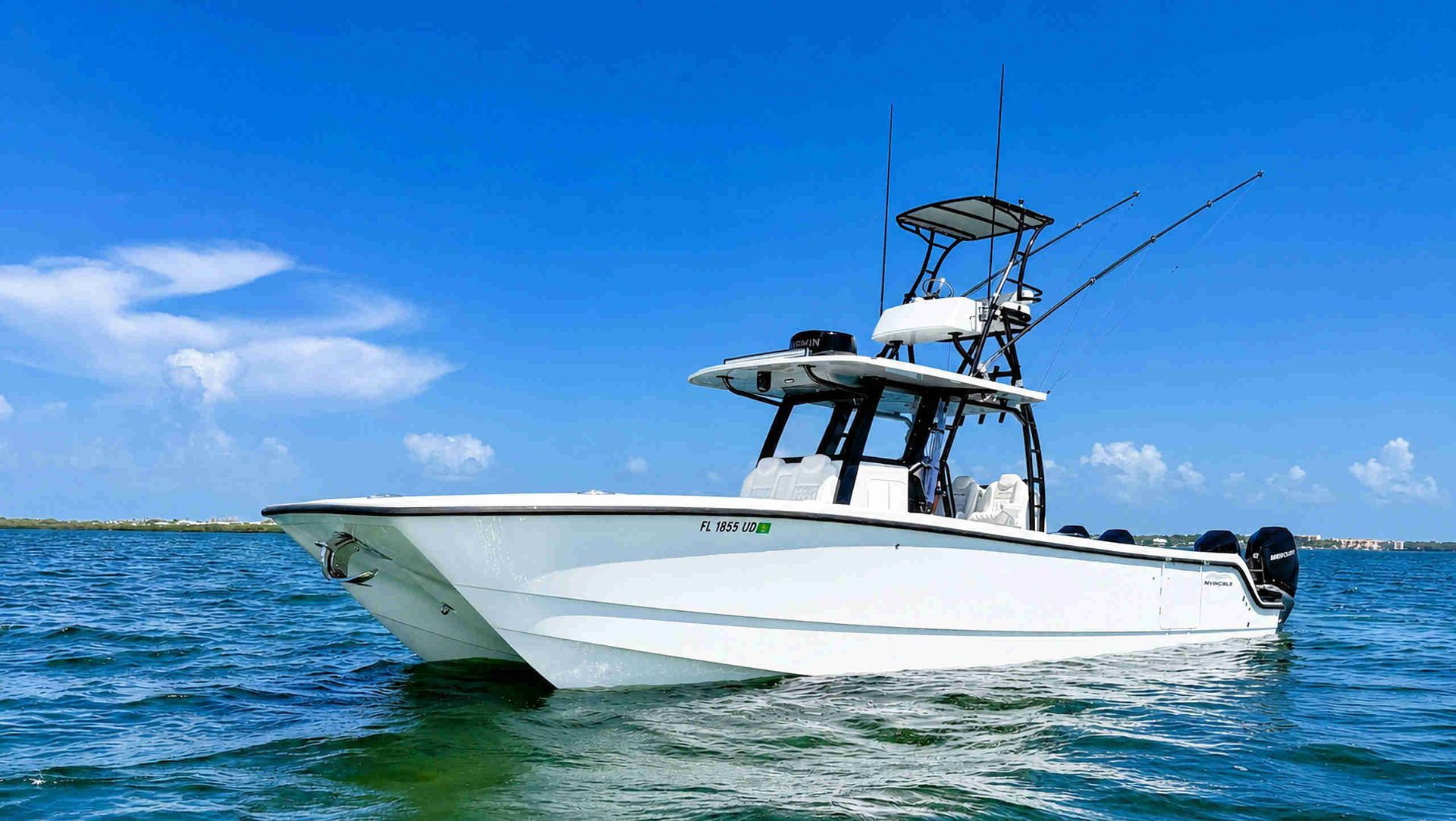 White catamaran center console fishing boat on blue ocean under a clear sky