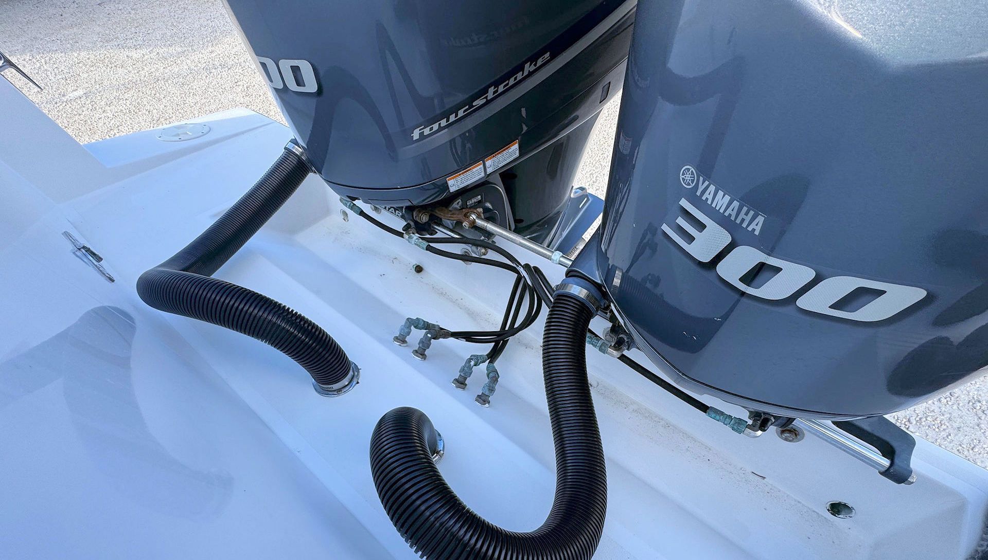 Close-up of two Yamaha 300 outboard motors on a boat stern in snowy conditions