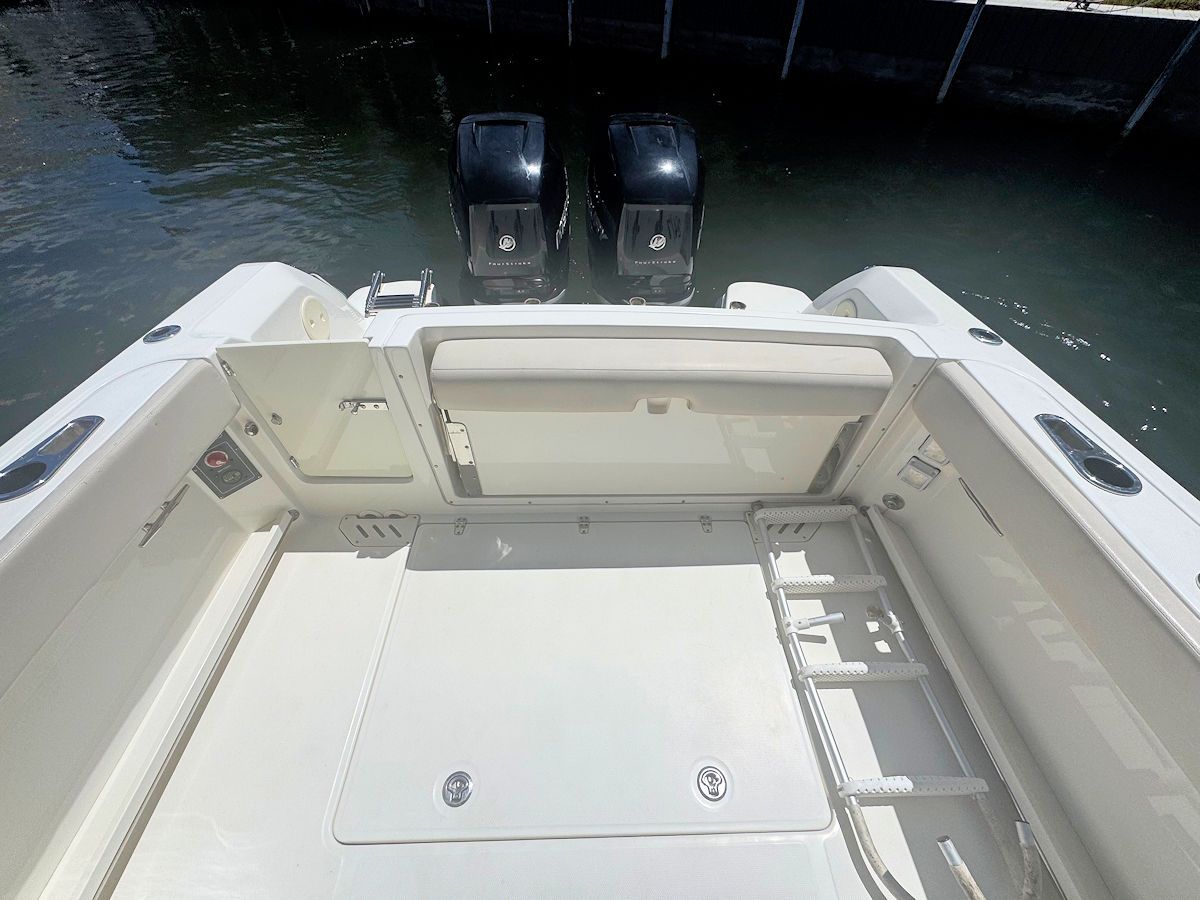 View from the back of a white boat with two black outboard motors.