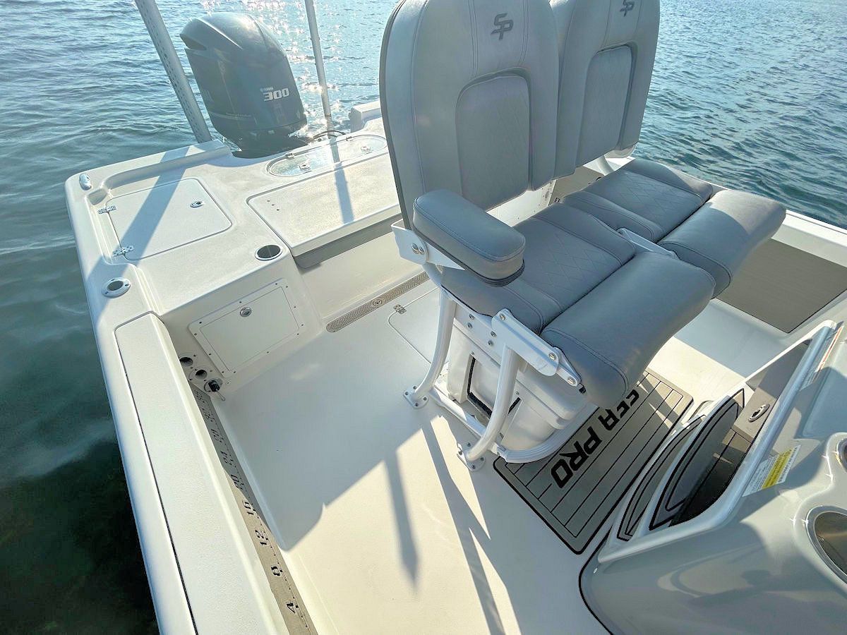 Boat deck with a double seat, mounted on a white, water-filled background.