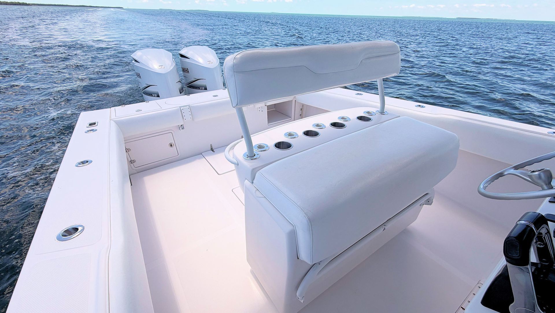 White leaning post at the helm with open blue ocean in the background