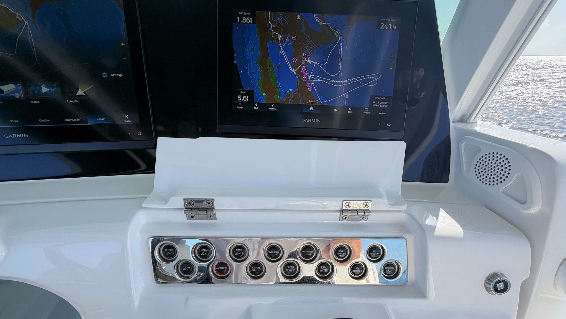 Boat helm with multiple audio/connector ports below navigation screens