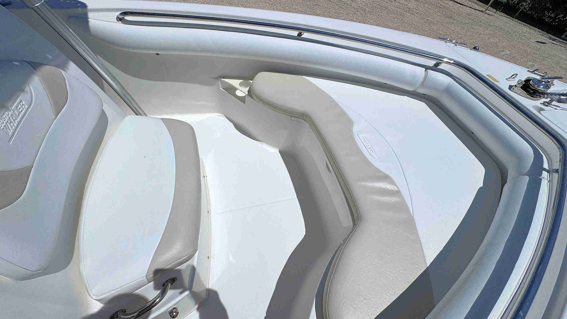 White boat seats with gray trim inside a clean white interior compartment