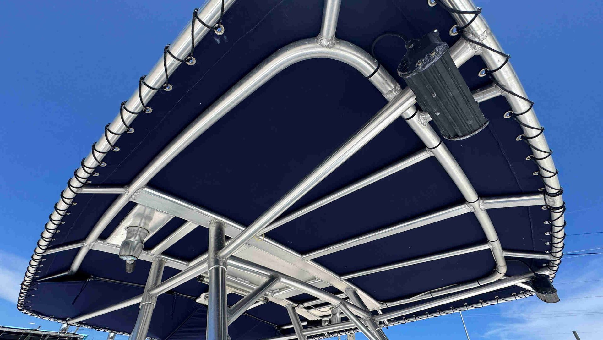 Blue canvas t-top seen from below against a bright sky