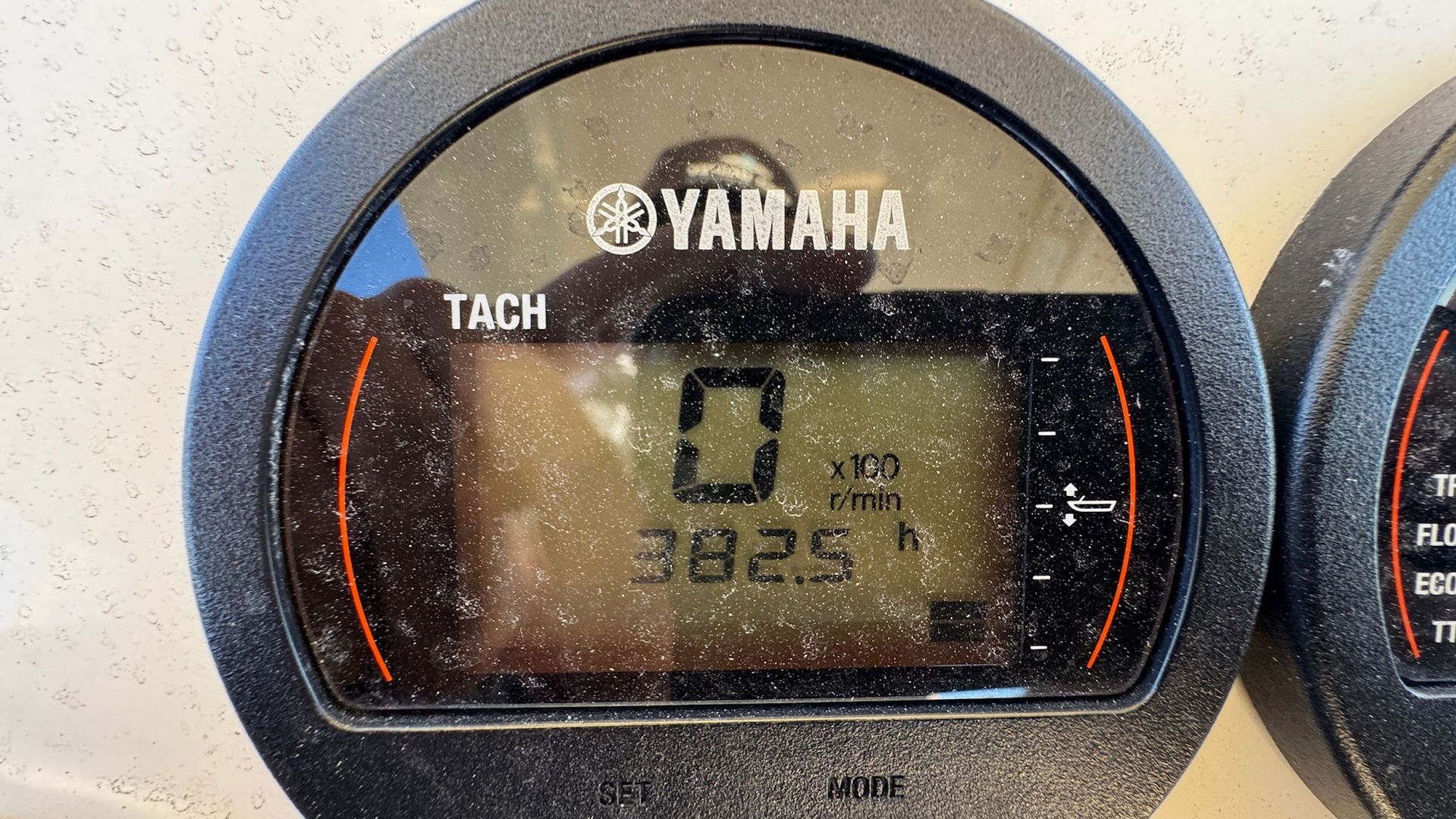 Yamaha digital tachometer showing 0 mph and 302.5 miles, with orange backlight
