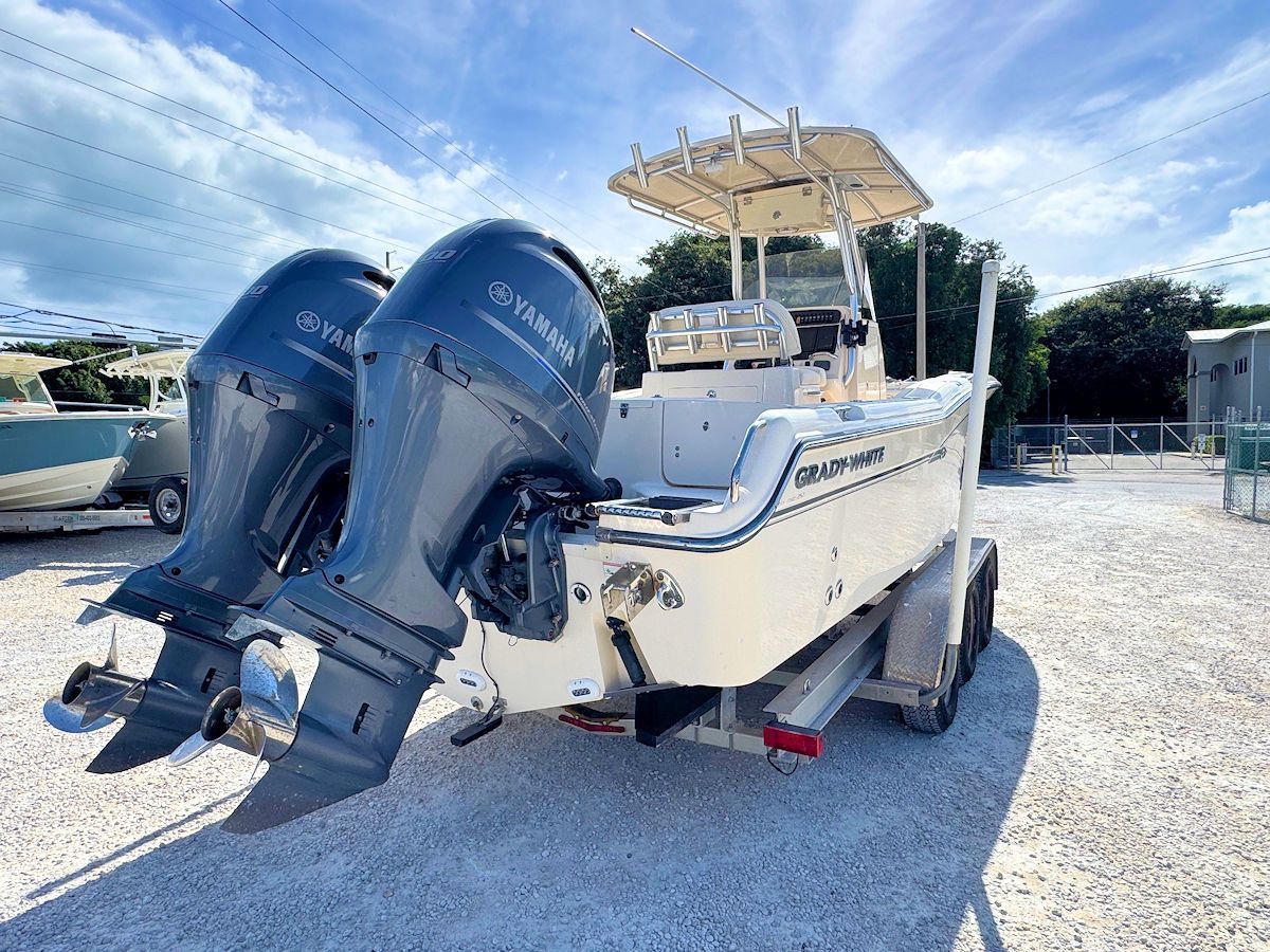 Boat with two Yamaha outboard motors on a trailer, sunny outdoor setting.