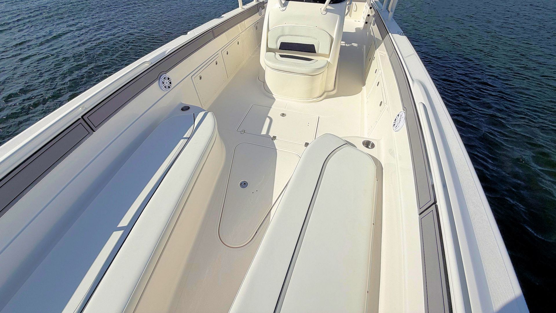 View from the bow of a white boat cruising on open water
