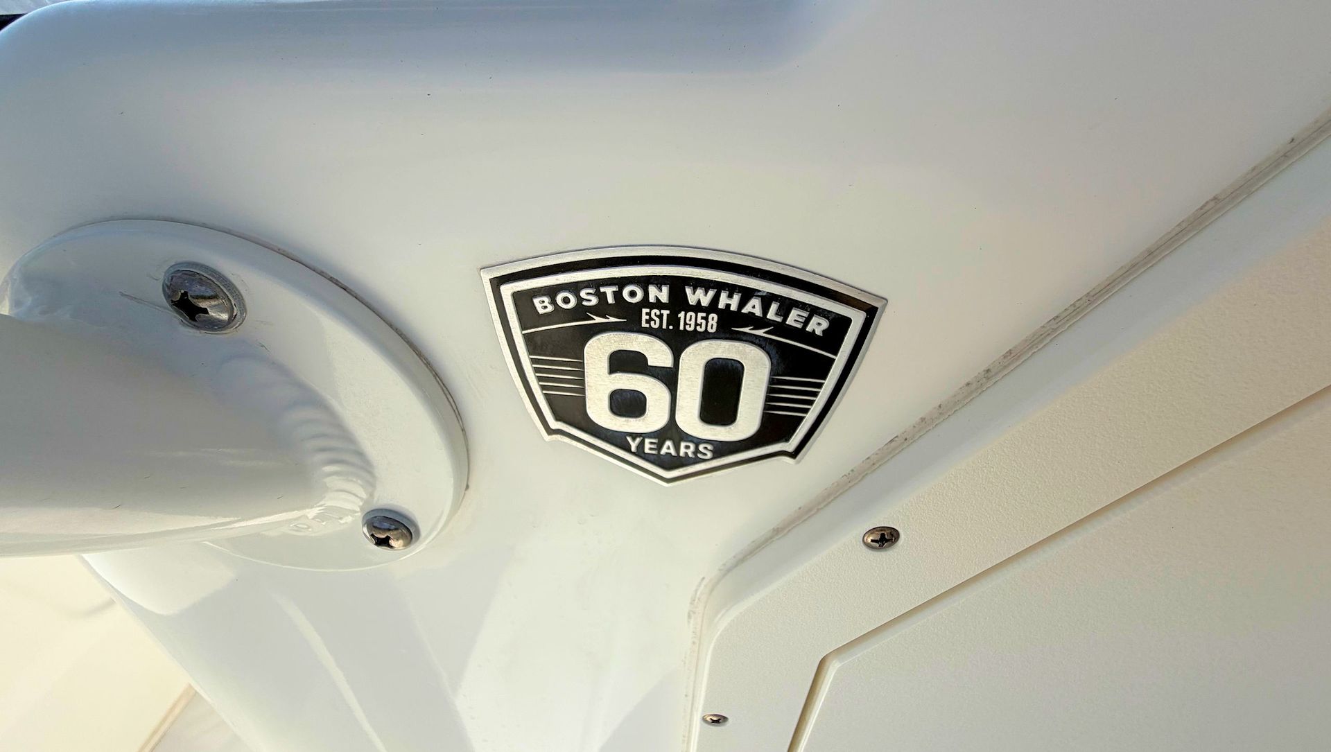 Boston Whalers 60 badge on a white boat interior panel