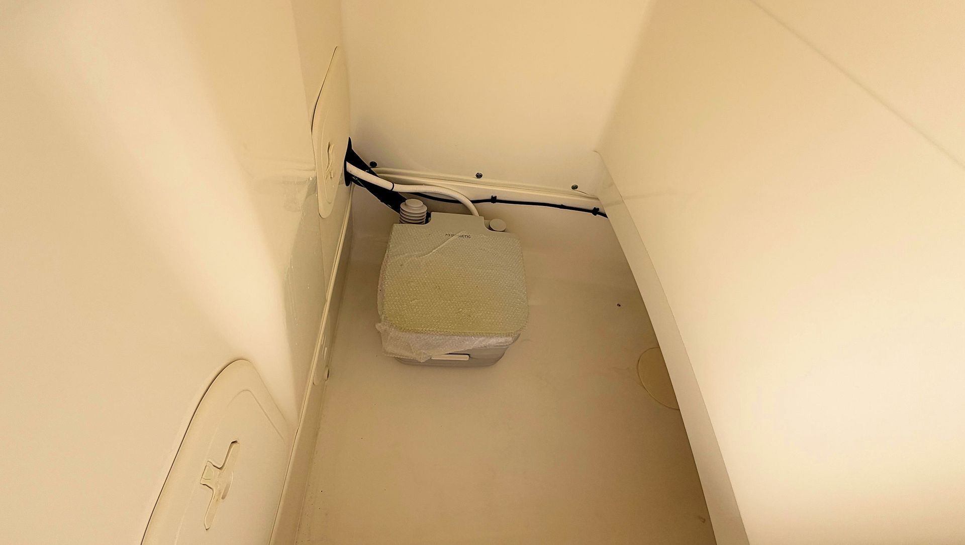 Toilet in under center console.