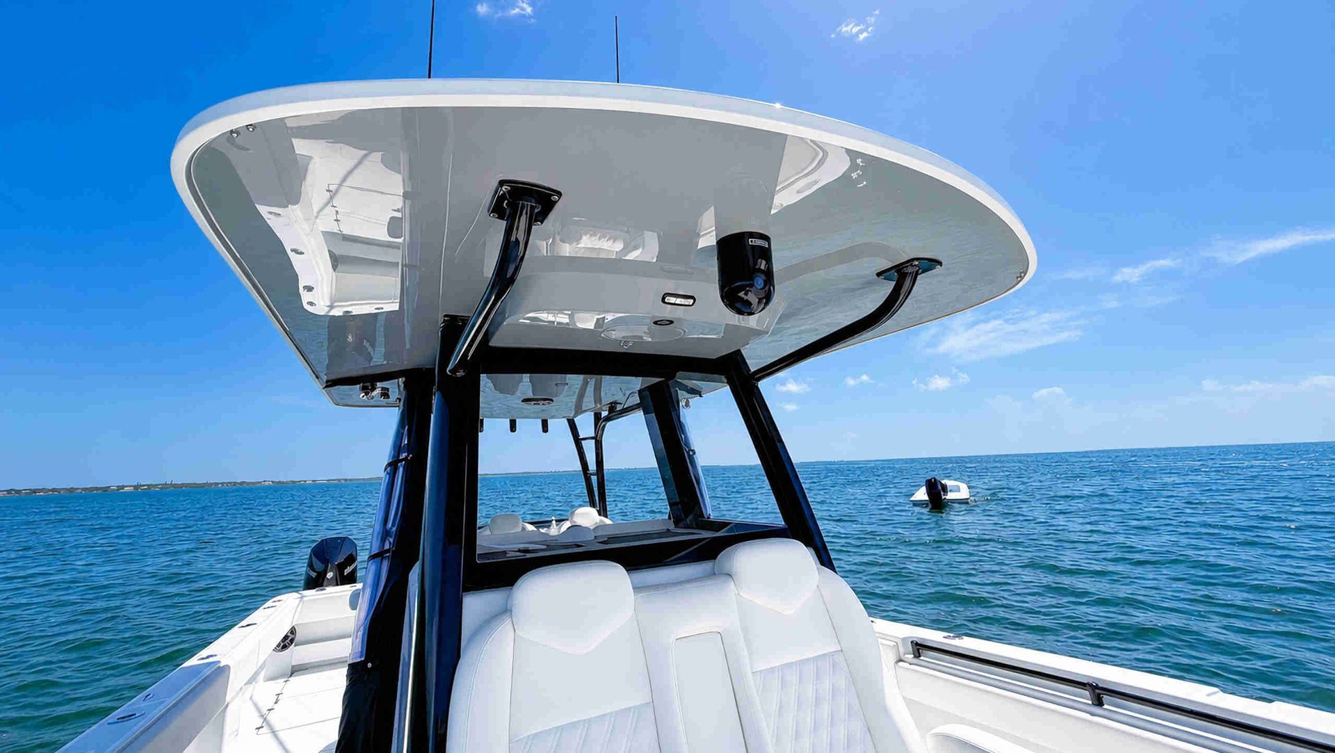 Boat t-top, facing a calm blue ocean under clear sky