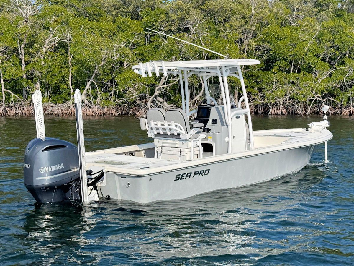 Gray Sea Pro boat on water with Yamaha motor, mangrove trees in the background.