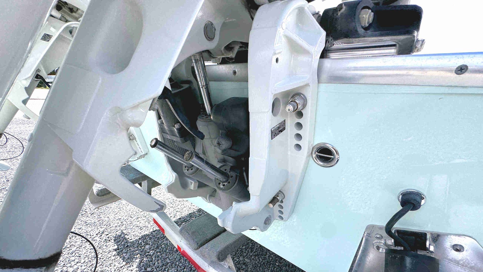 Close-up of outboard motor mounting brackets and associated equipment