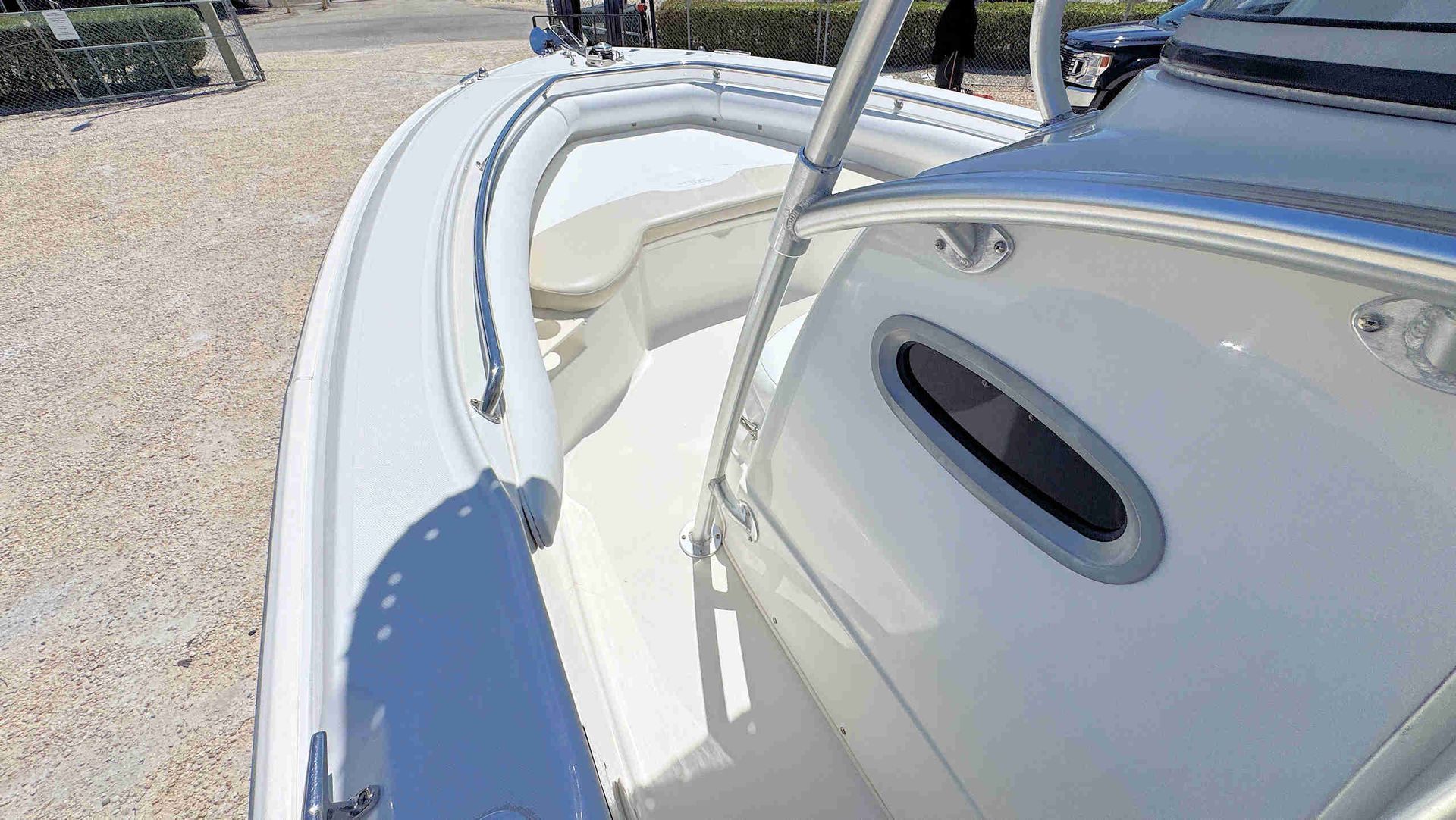 White cushioned boat seating in bow of this boat.
