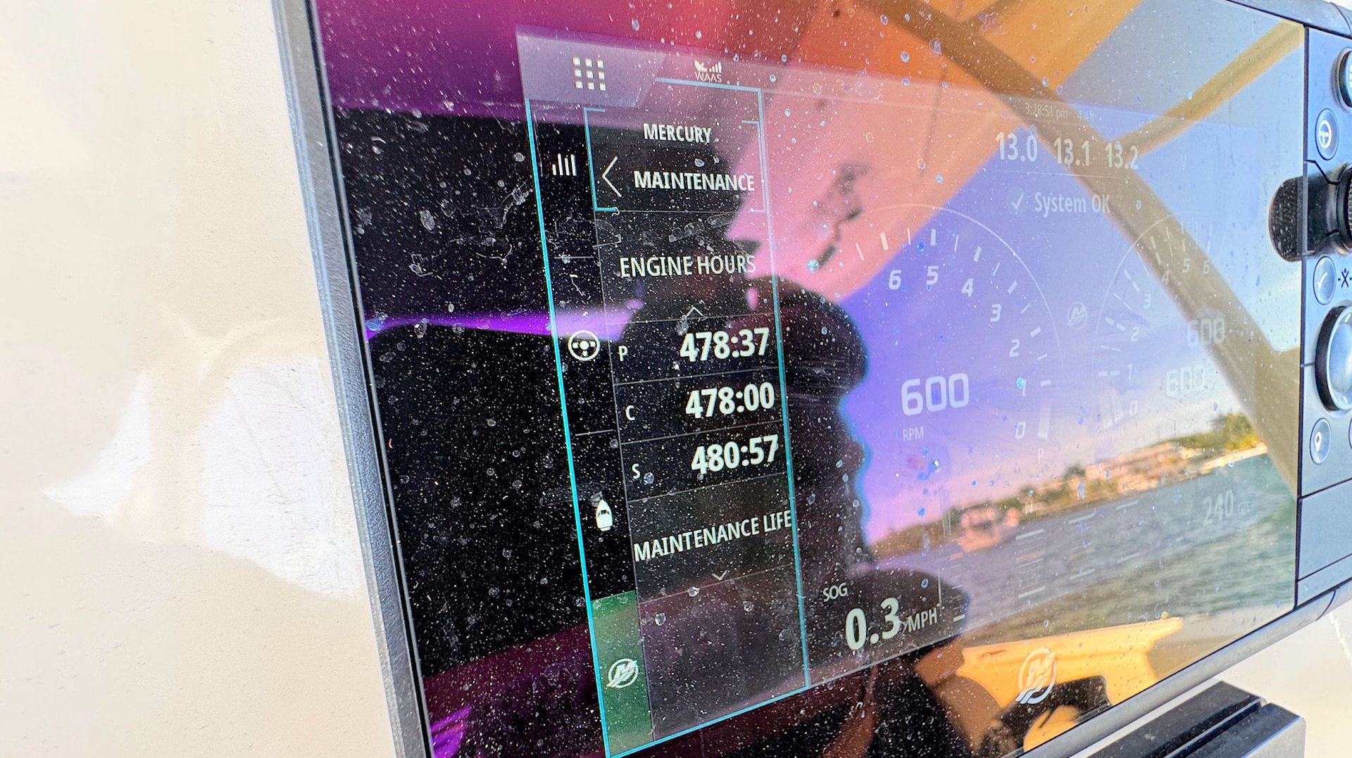 Close-up showing engine hours,  dashboard interface with numbers and reflections