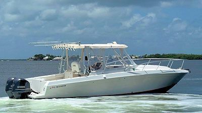 A white boat is floating on top of a body of water.