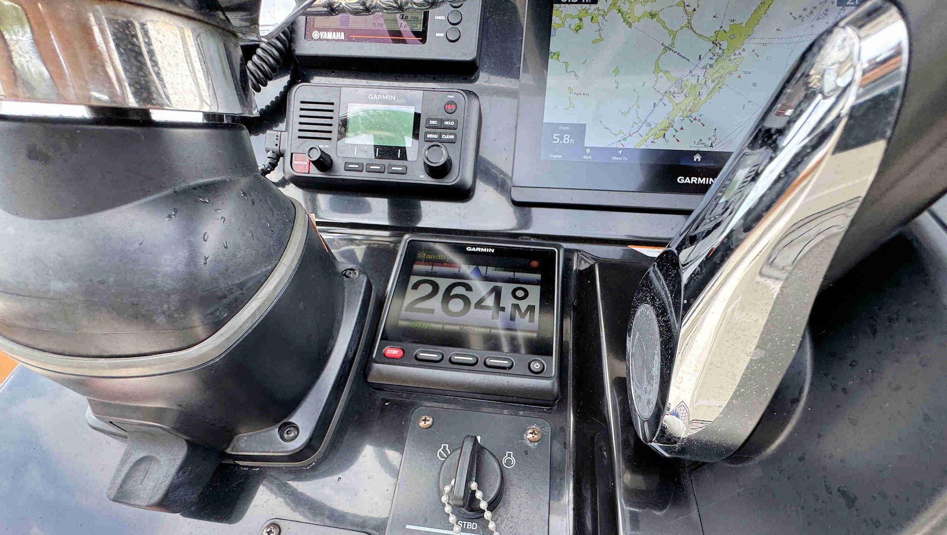 GPS device and dashboard controls inside a vehicle, with a map display and chrome gear lever