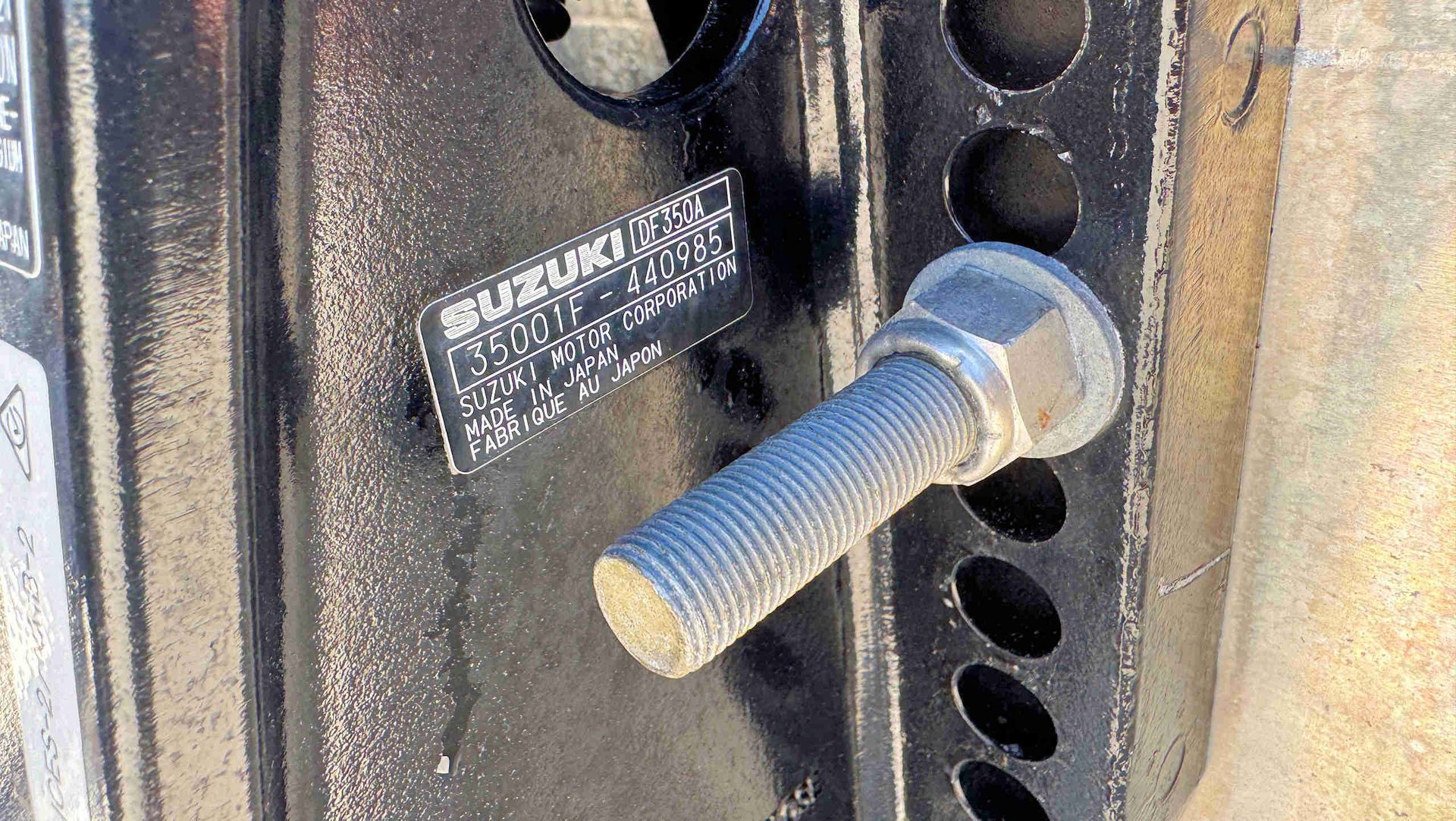 Close-up of a Suzuki engine information label.