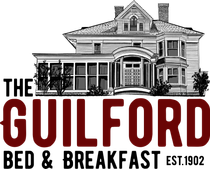 A black and white logo for the guilford bed and breakfast