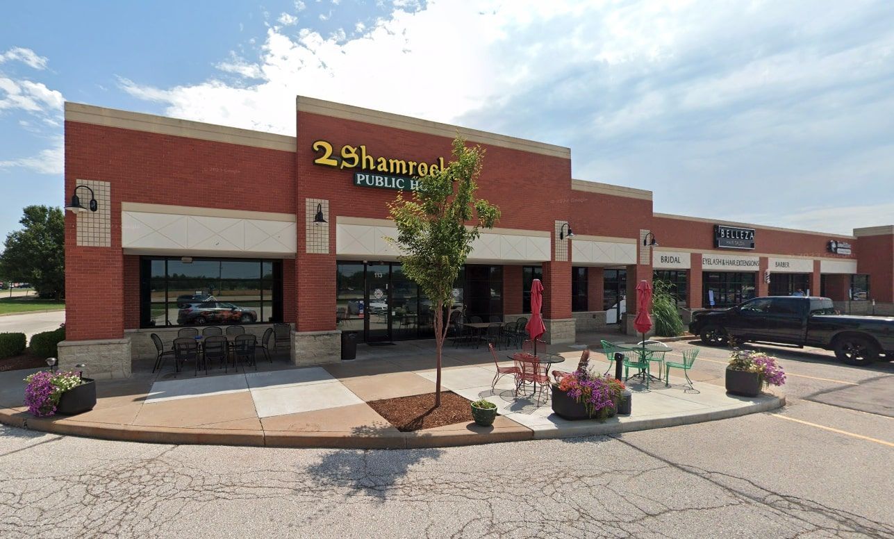 An exterior view of the restaurant Two Shamrocks in O'Fallon, MO, featuring its red brick building.