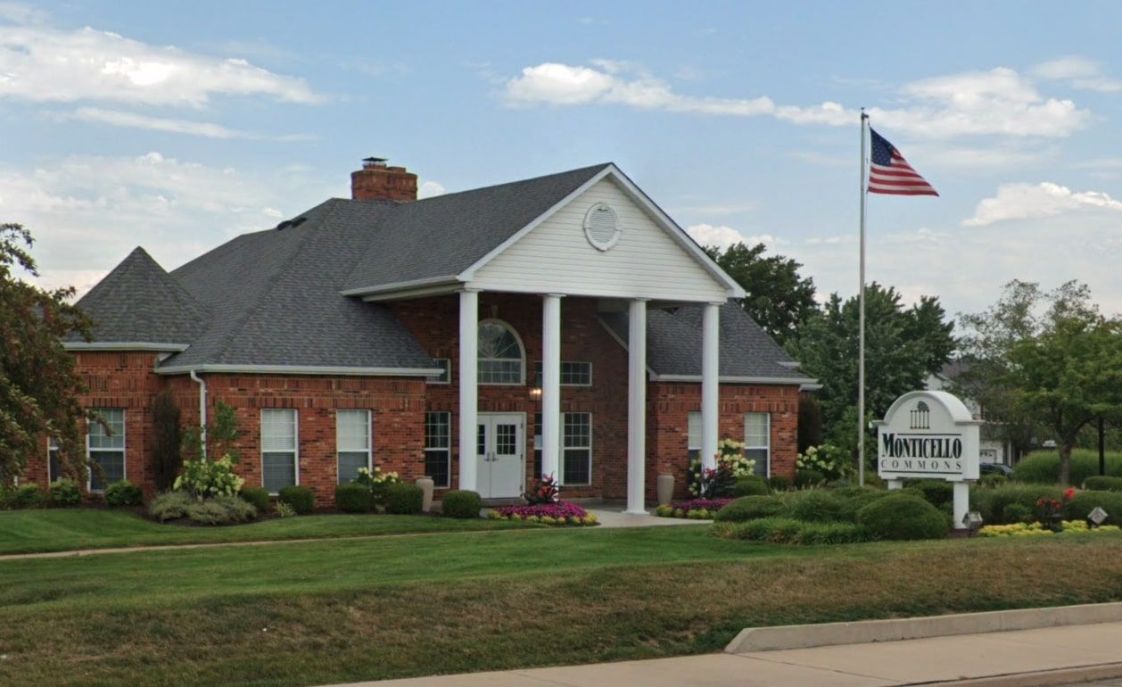 The Monticello Commons showing a brick built facility with a white sign.