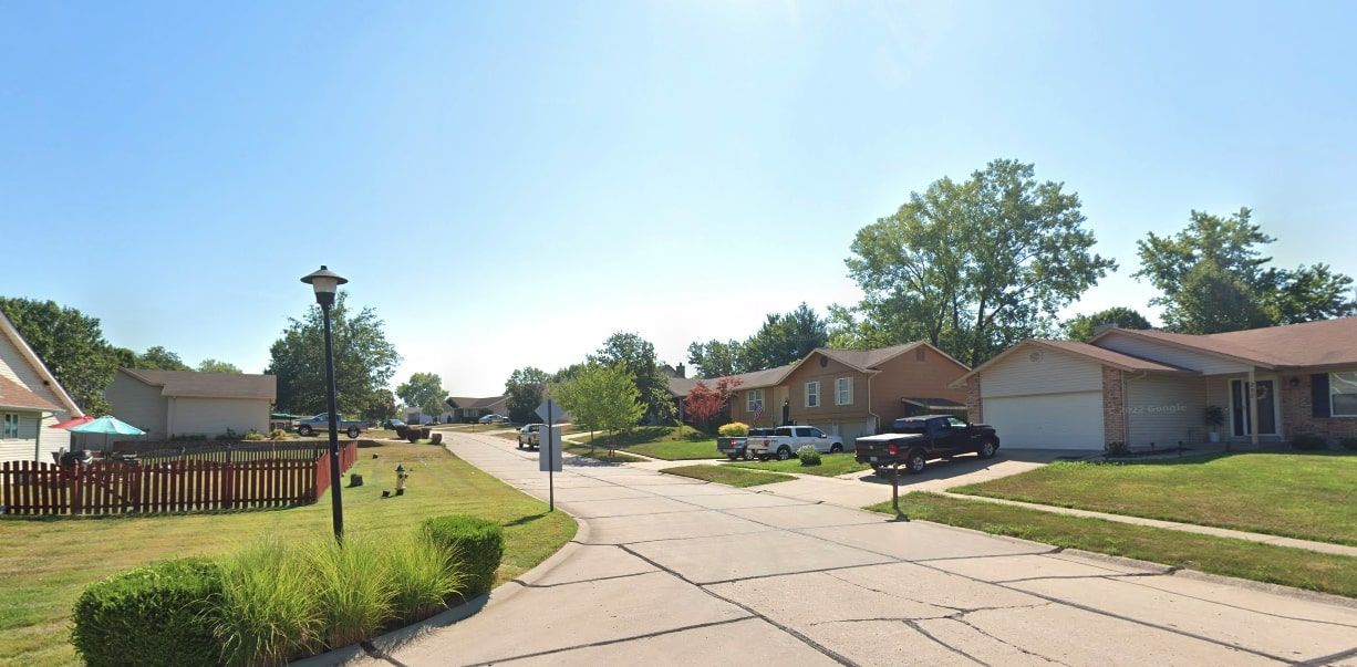 The beautiful neighborhood of Westbridge featuring brown houses and a green landscape