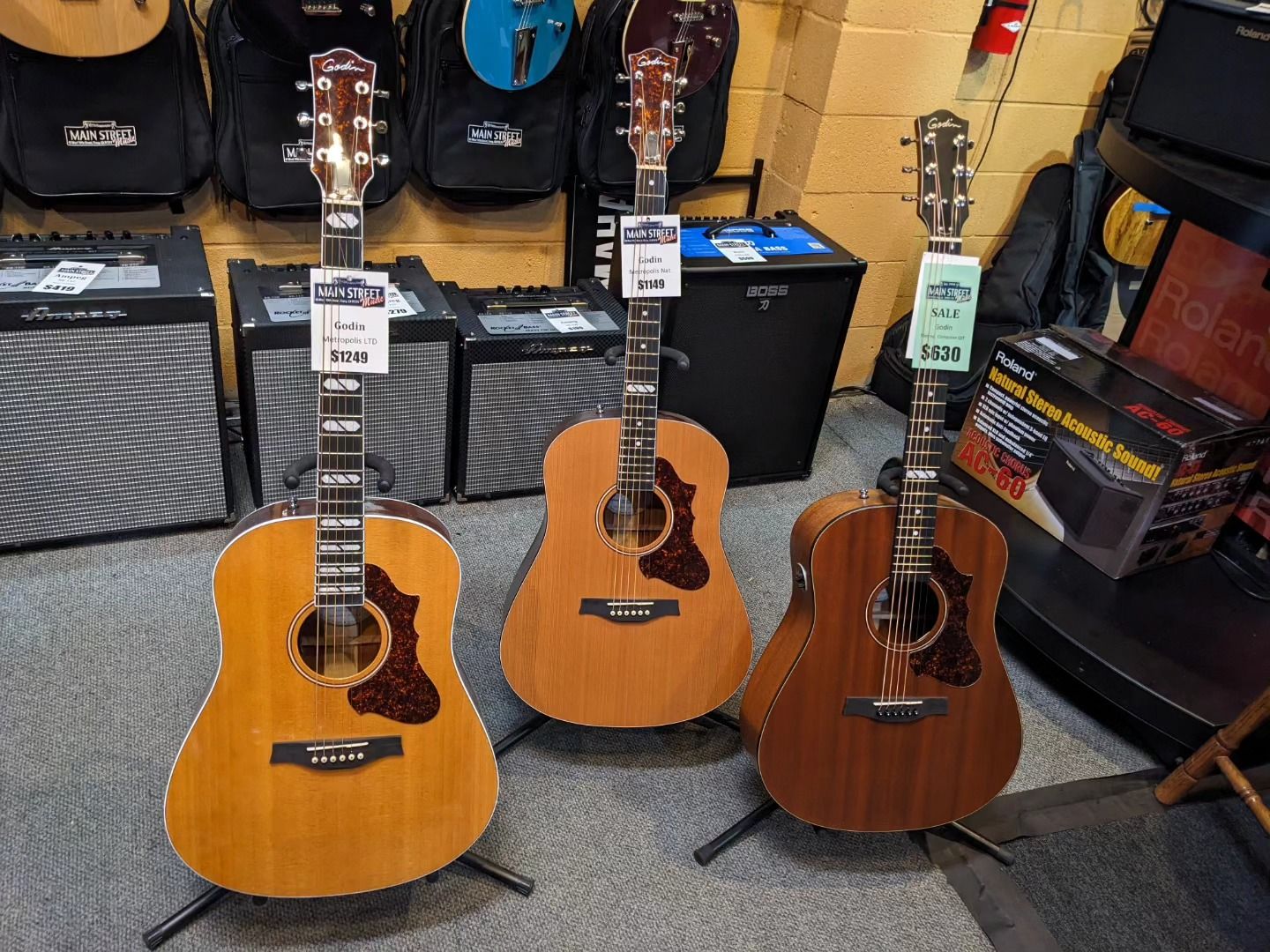 three acoustic guitars are on display in a store