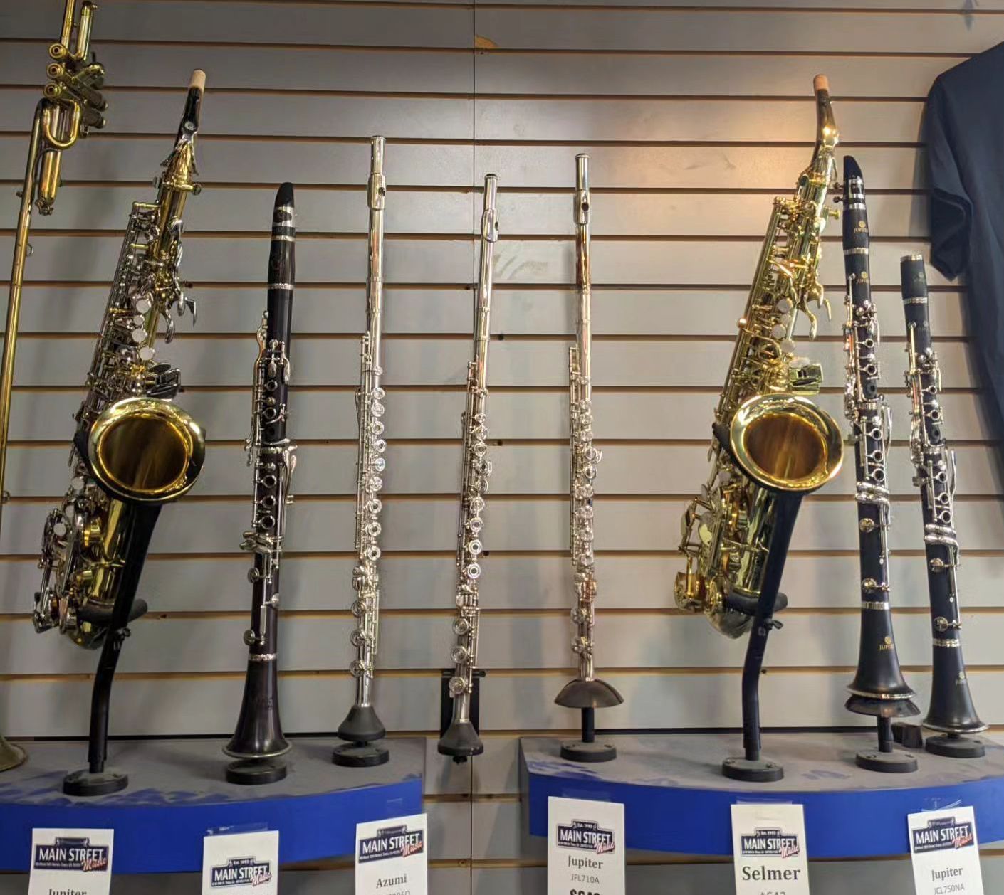 a display of saxophones and clarinets in a store