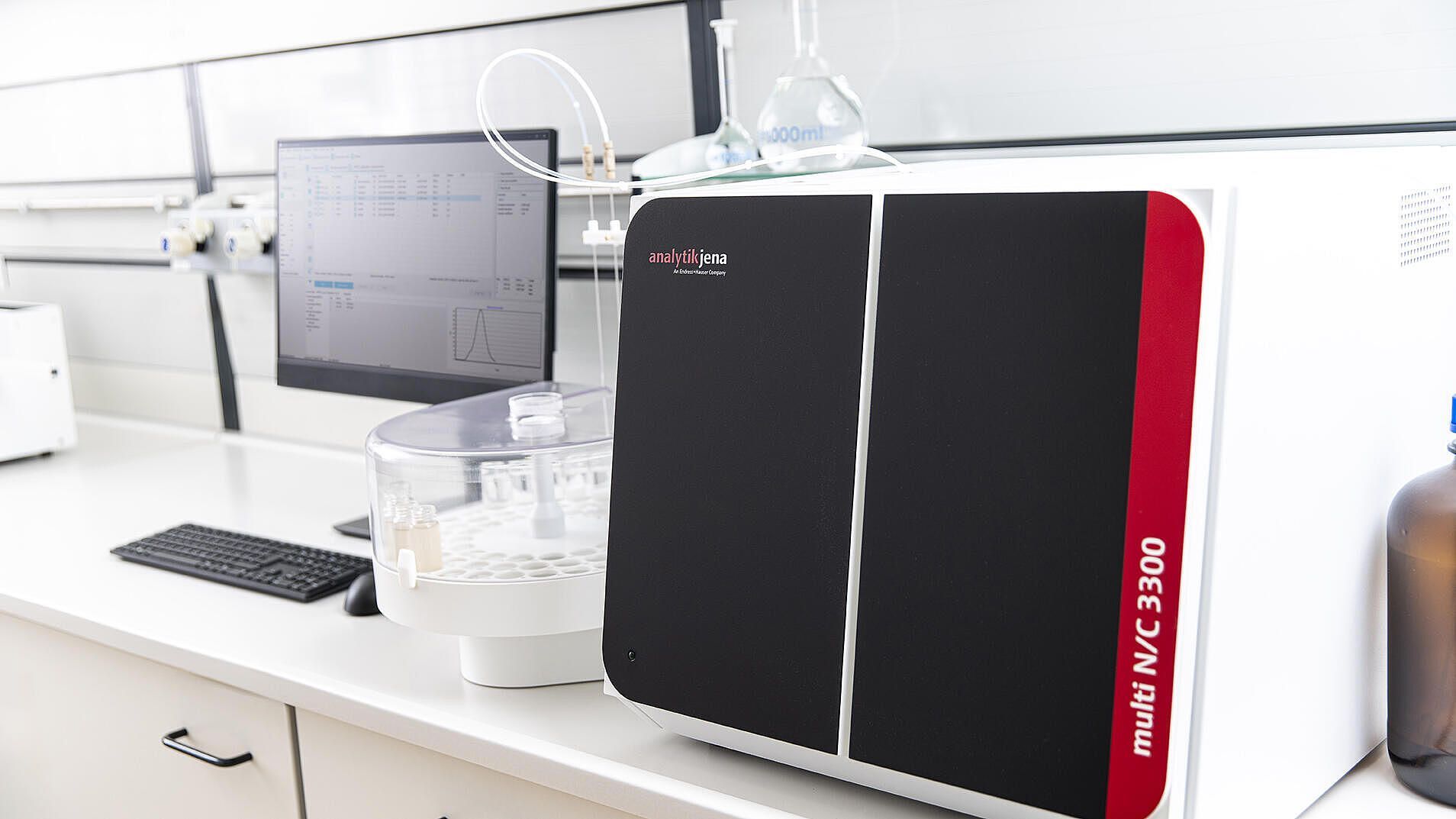 Red and white laboratory device on a plain background