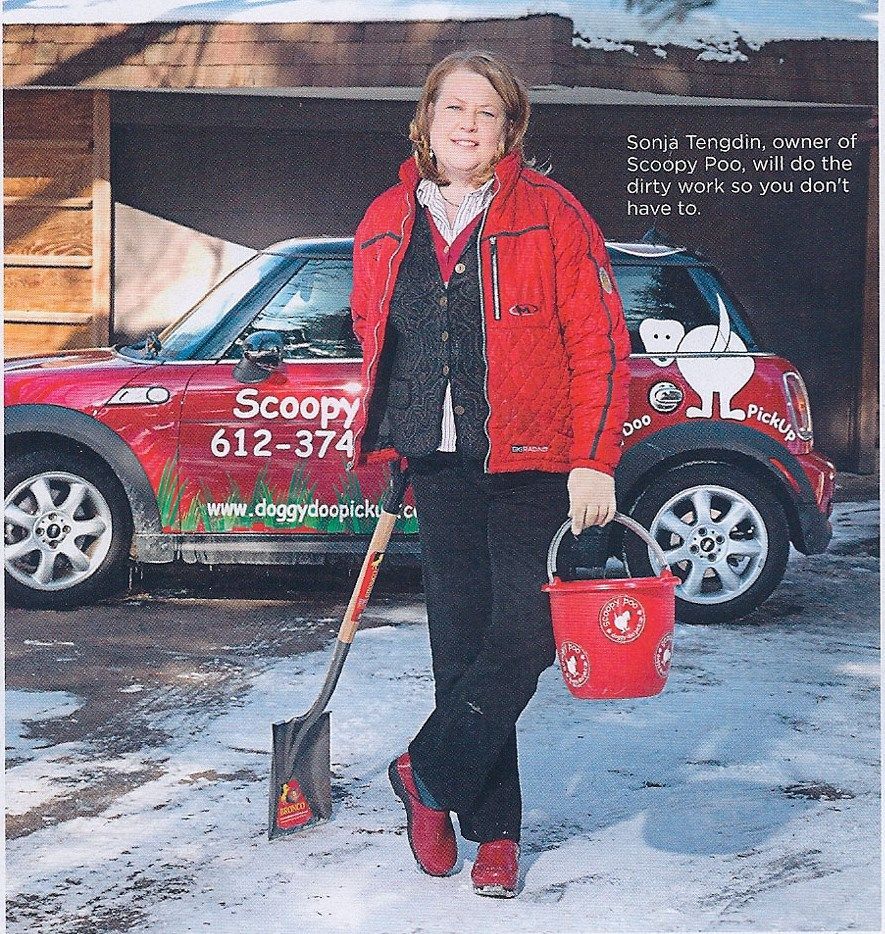 Woman in red jacket holds bucket and shovel, stands by red car with 