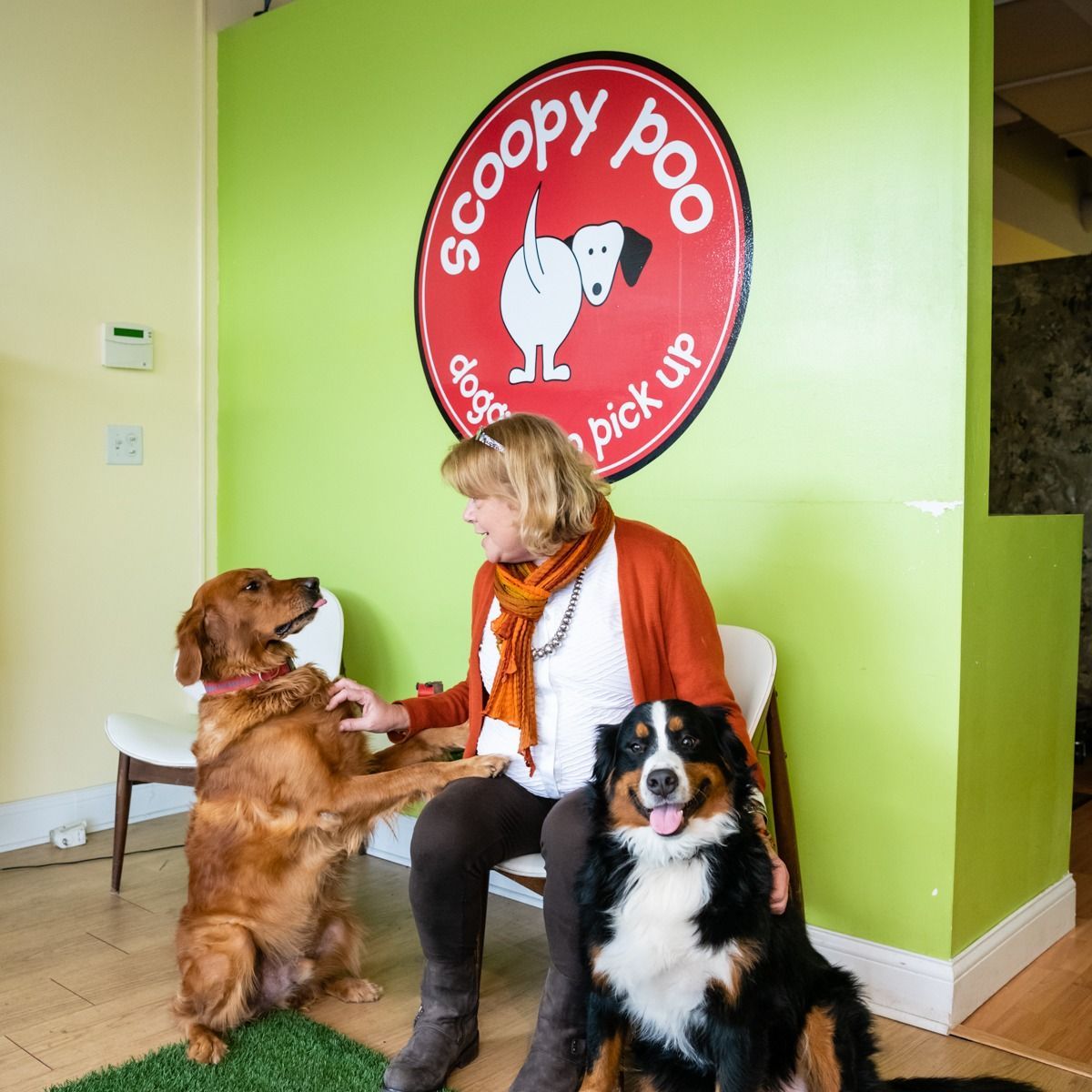 Woman sitting with two dogs under a 
