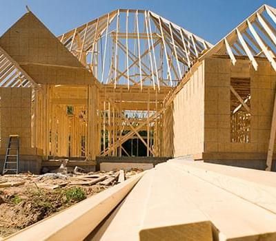 A house that is being built with a lot of wood