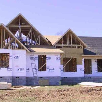 A large house is being built in a field.