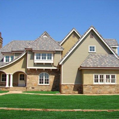 A large house with a lot of windows and a gray roof