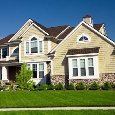 A large house with a lush green lawn in front of it