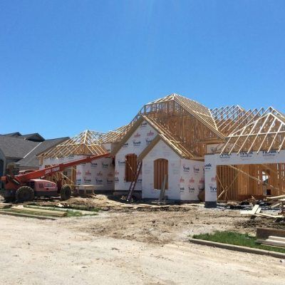 A large house is being built in a residential area.