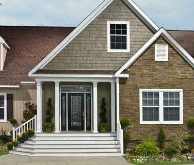 A house with a large porch and stairs leading up to it.