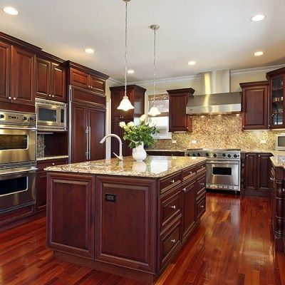 A kitchen with stainless steel appliances and wooden cabinets