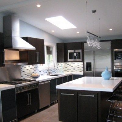 A kitchen with stainless steel appliances and a large island