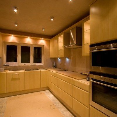 A kitchen with stainless steel appliances and wooden cabinets