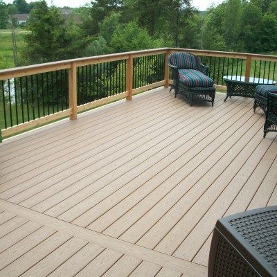 A wooden deck with chairs and a table on it