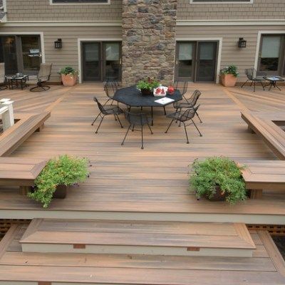 A wooden deck with a table and chairs on it