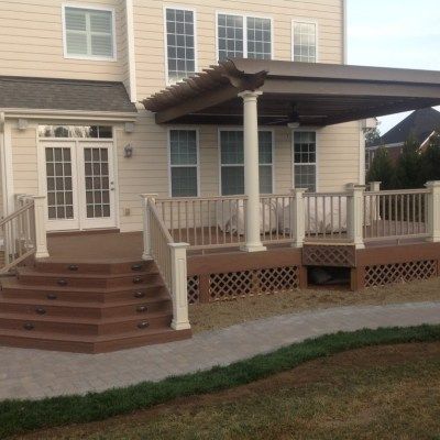 A large house with a large deck and stairs