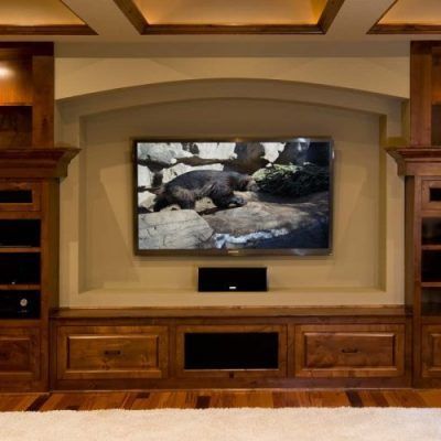 A living room with a large flat screen tv on the wall