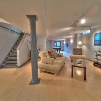 A living room with a couch a chair and a table