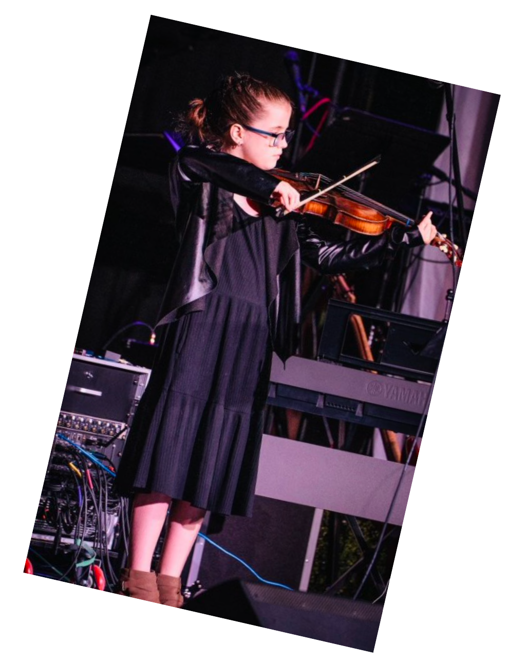 A woman in a black dress is playing a violin