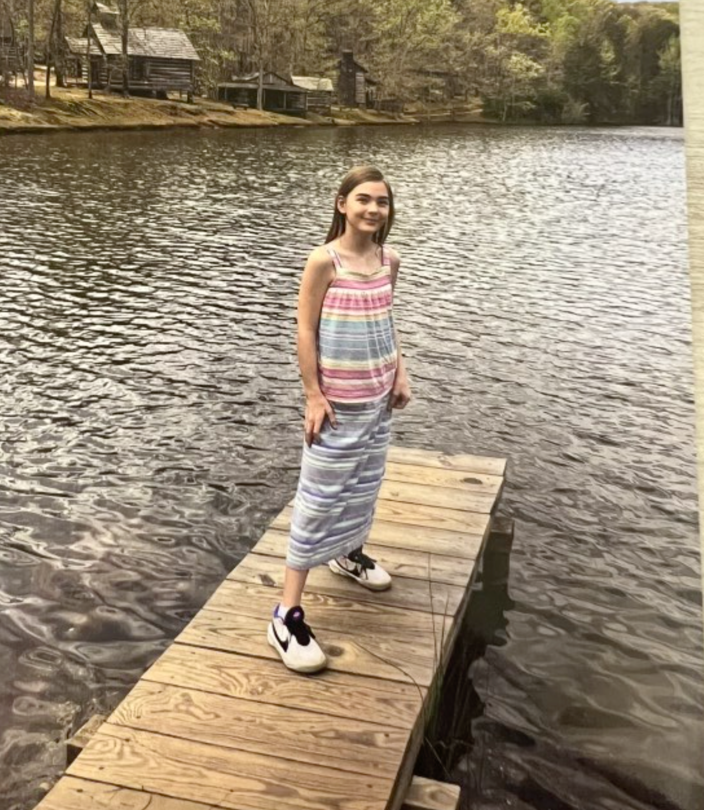 A woman in a black dress is playing a violin