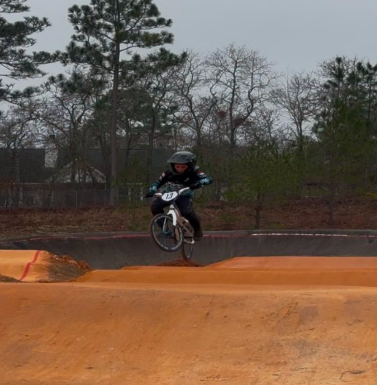 A woman in a black dress is playing a violin