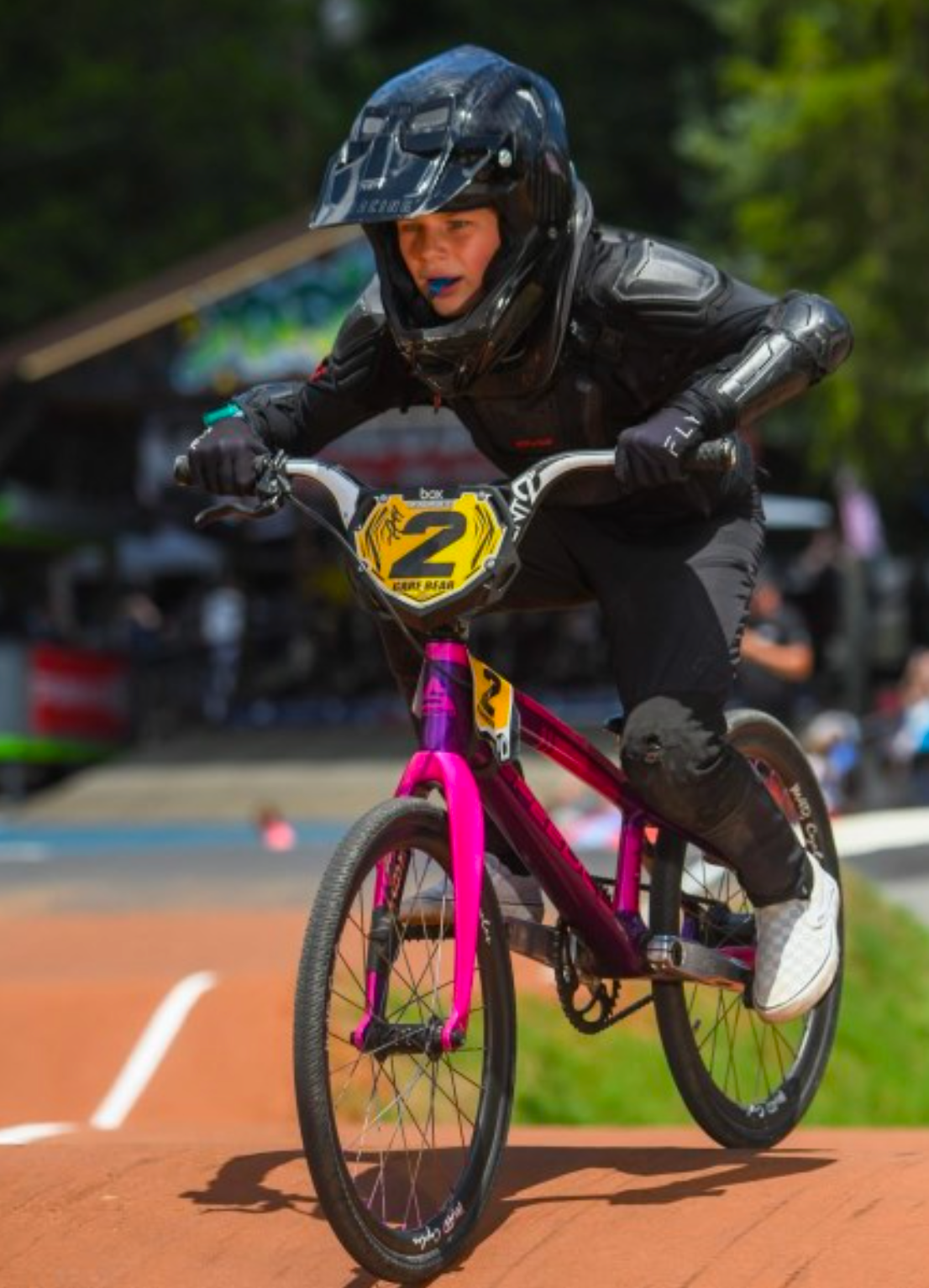 A woman in a black dress is playing a violin