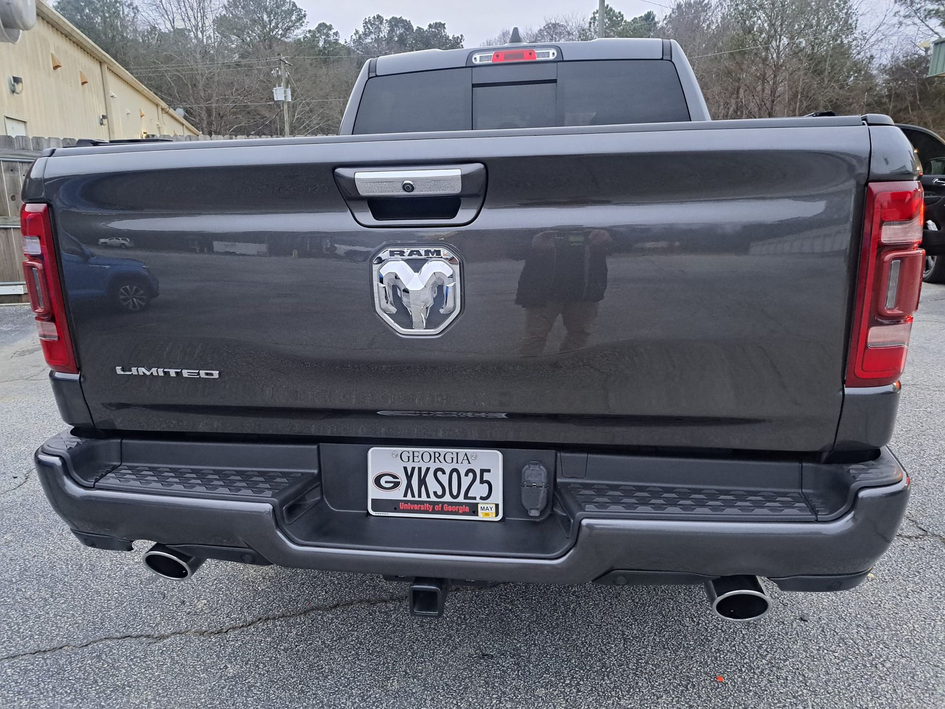The back of a gray ram truck with a license plate that says ksd25