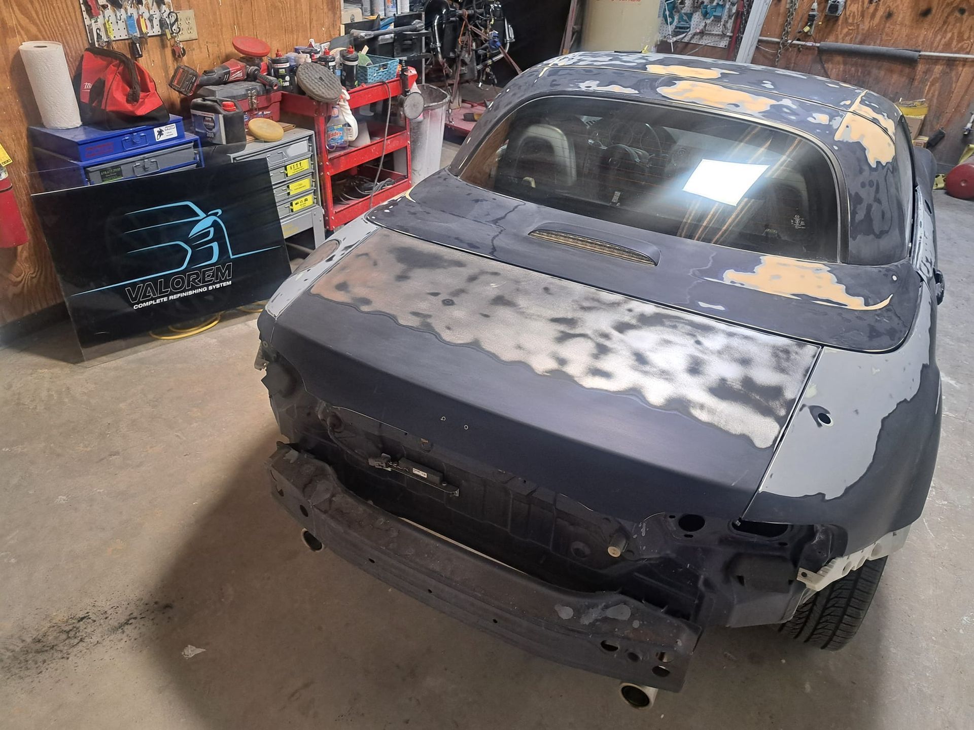 A car is being worked on in a garage.